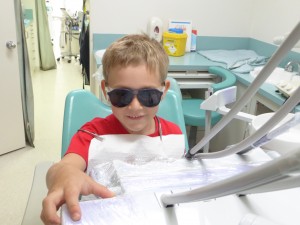 Boy operating dental chair